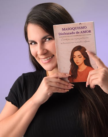 Smiling woman holding her book Masoquismo Disfrazado de Amor against a purple background.