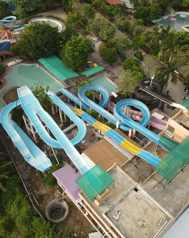 a water slider with a slider in the middle of a large pool