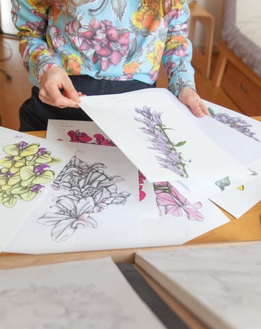 A desk filled with botanical illustrations