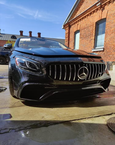 an Enlab Mercedes car parked in a driveway with a car in the background