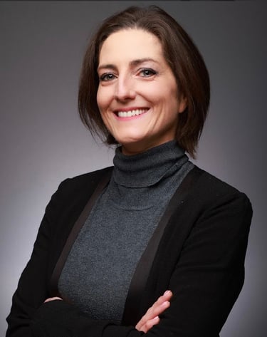 Portrait Louise Mac Sweeney Funeral Celebrant Grey Polo, black blazer, arms crossed