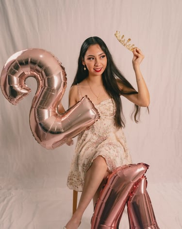 a woman in a dress and tiablet holding a crown