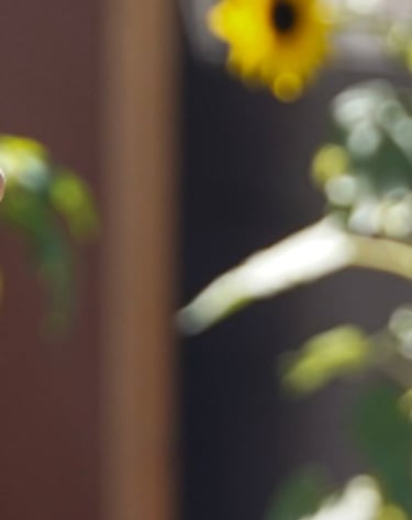 Iveth Balanta holding a leafy plant in her hand