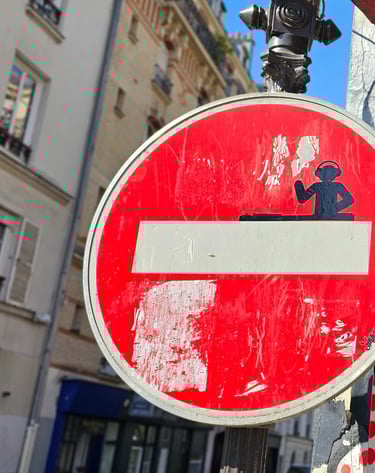 a red and white sign with a no entry sign