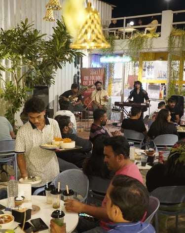 a man serving food to a crowd of people in live music event
