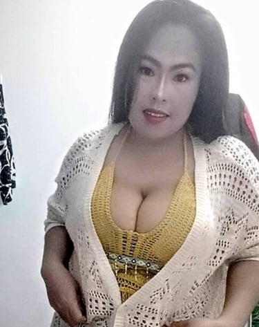 Lady wearing yellow top , black skirt and cream mesh design cardigan