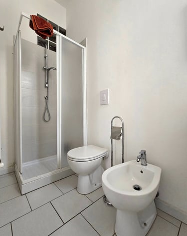 a bathroom with a toilet and a shower