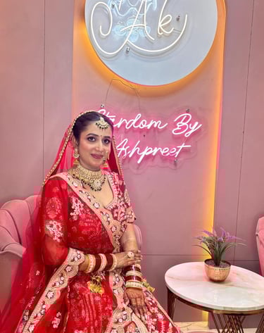 Indian bride in classic red lehenga with HD bridal makeup, gold jewelry, mehendi, and dupatta drape,