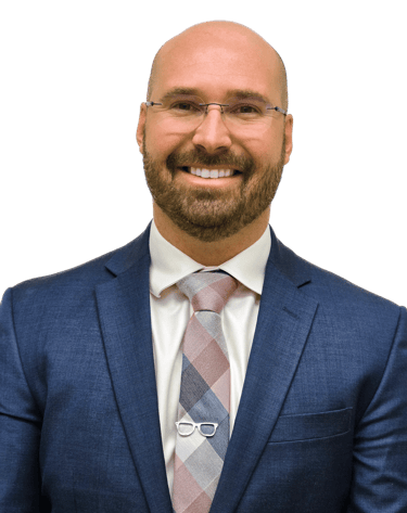 man in a suit with glasses wearing a tie