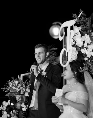 a man and woman standing in front of a microphone