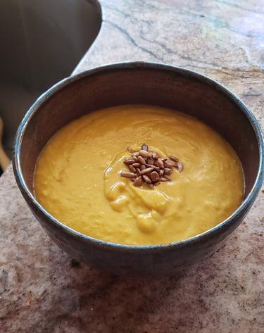 a bowl of soup with sunflower seeds in it