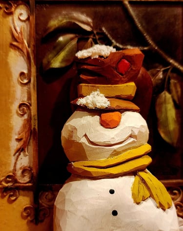 hand carved snowman with tophate and scarf, carved in basswood by James Smith