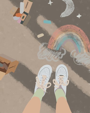 a person standing on a sidewalk with a rainbow painted on the sidewalk