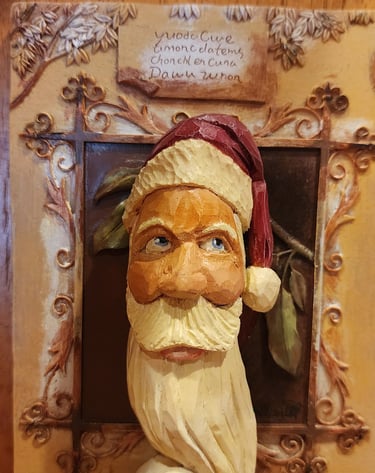 hand carved santa with hate and long curling bear, carved by James Smith