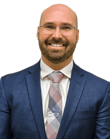 man in a suit with glasses wearing a tie