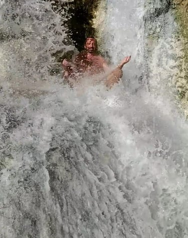 a man meditating in a waterfall in the middle of a waterfall