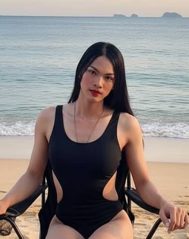 Ladyboy wearing a swimsuit and sitting on a chair on Pattaya Beach, Thailand.