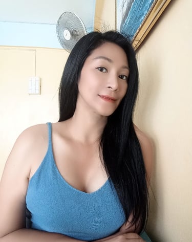 half body photo of a lady with long black hair and a blue crop top