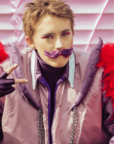 a woman with a purple jacket and red feathers