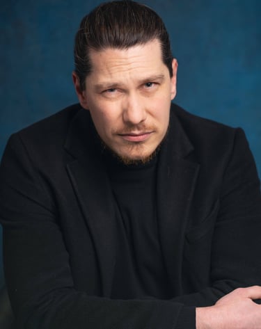 a man in a black suit and a black jacket