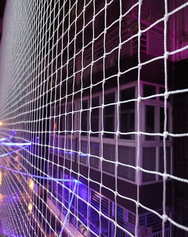 Wide shot of an open area surrounded by durable safety nets on Sarjapur Road.