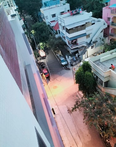 Safety net stretched tightly across a window opening, protecting workers below.