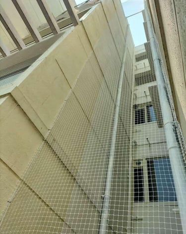 Technician from Arjilli Enterprises fitting a safety net on a duct area.