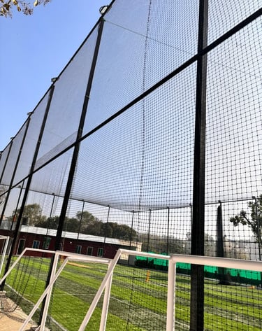 Technicians from Arjilli Enterprises carefully setting up a volleyball net in an outdoor Chennai par