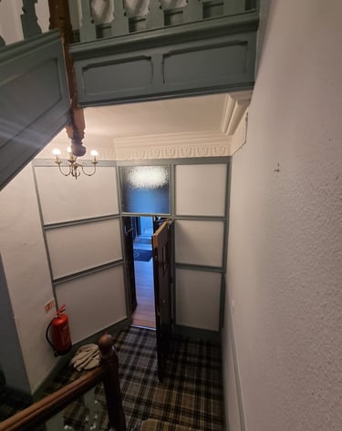 Walls near a doorway and landing finished and tidy.