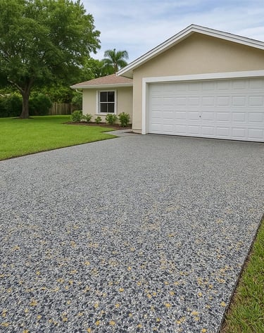 Durable, slip-resistant driveway with speckled polyaspartic epoxy coating in gray and yellow tones.