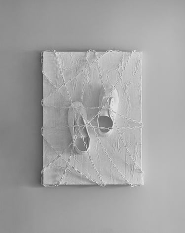 shoes tied by chains to a plastered canvas with footprint
