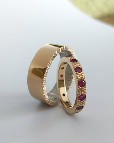 Hand fabricated wedding bands using 14kt yellow and white gold, set with Rubies by Kelly Allanson 
