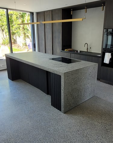 Polished concrete kitchen island with a sink and a sink