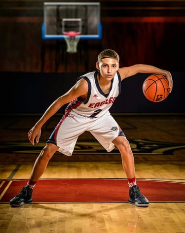 a man in a uniform is holding a basketball ball