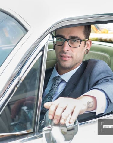 a man in a suit and tie is sitting in a car