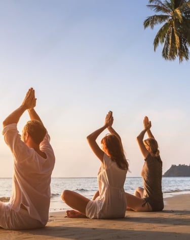 a group of people doing yoga on the beach