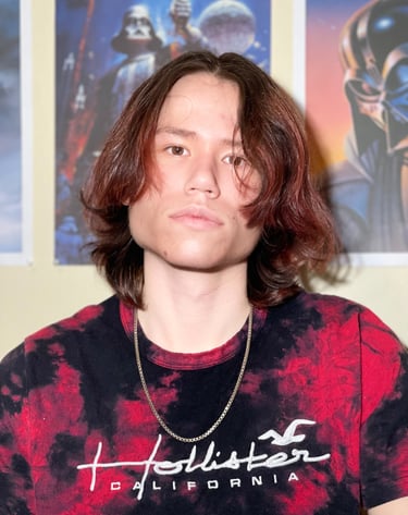 a man with long hair and a tie dye tshirt