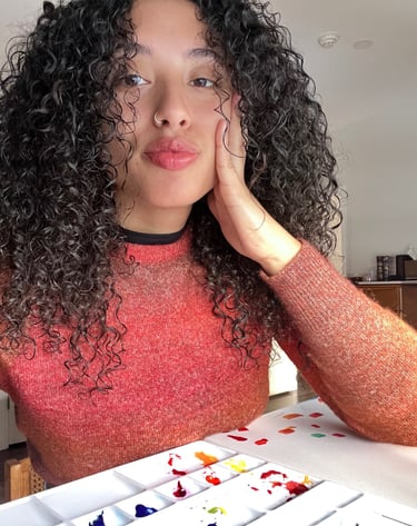 a woman with curly hair and a red sweater