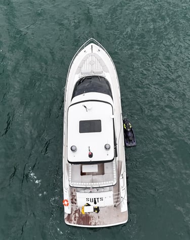 a boat with a man standing on the water