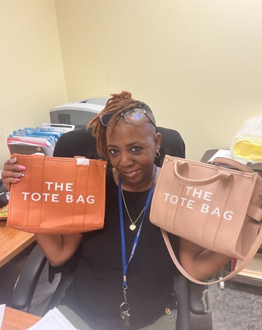 A woman holding up two designer-style tote bags in orange and tan colors.