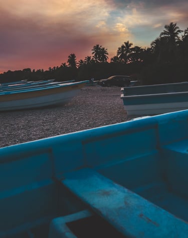 Editorial travel photograph of a coastal scene with boats at sunset, emphasizing place & atmosphere