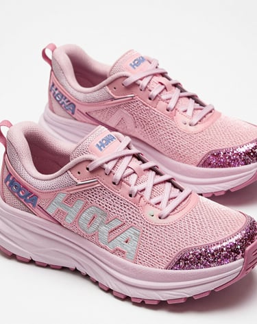 A cute collection of plush toys arranged on a cozy bed with ruffled blankets.