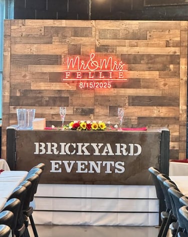 Wedding head table decorated with elegant place settings, floral arrangements, and soft lighting at 