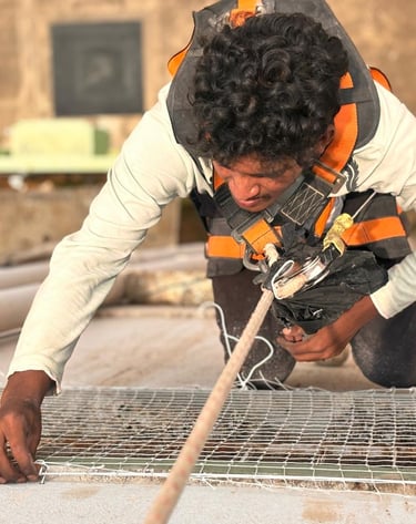 Expert technician installing pigeon net on a high-rise balcony in mumbai.
