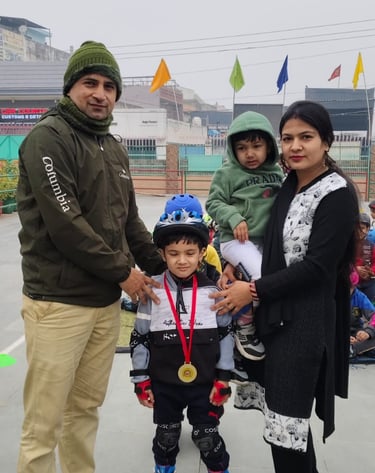 A proud family posing with a young boy wearing inline skates, a helmet, and a gold medal.