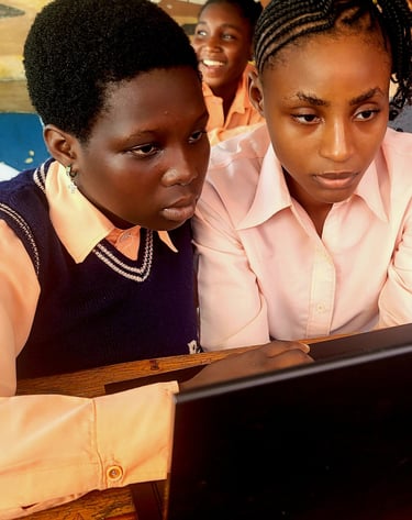 Girls using the computer at school