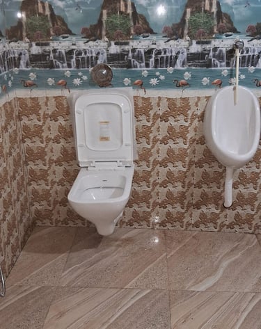 a bathroom with a toilet and urinals