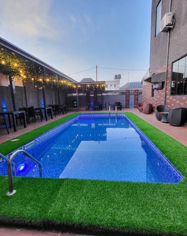 Outdoor swimming pool area with loungers.