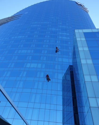 Two men hanging from a high riser