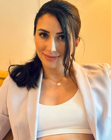 a woman in a white top and a white jacket